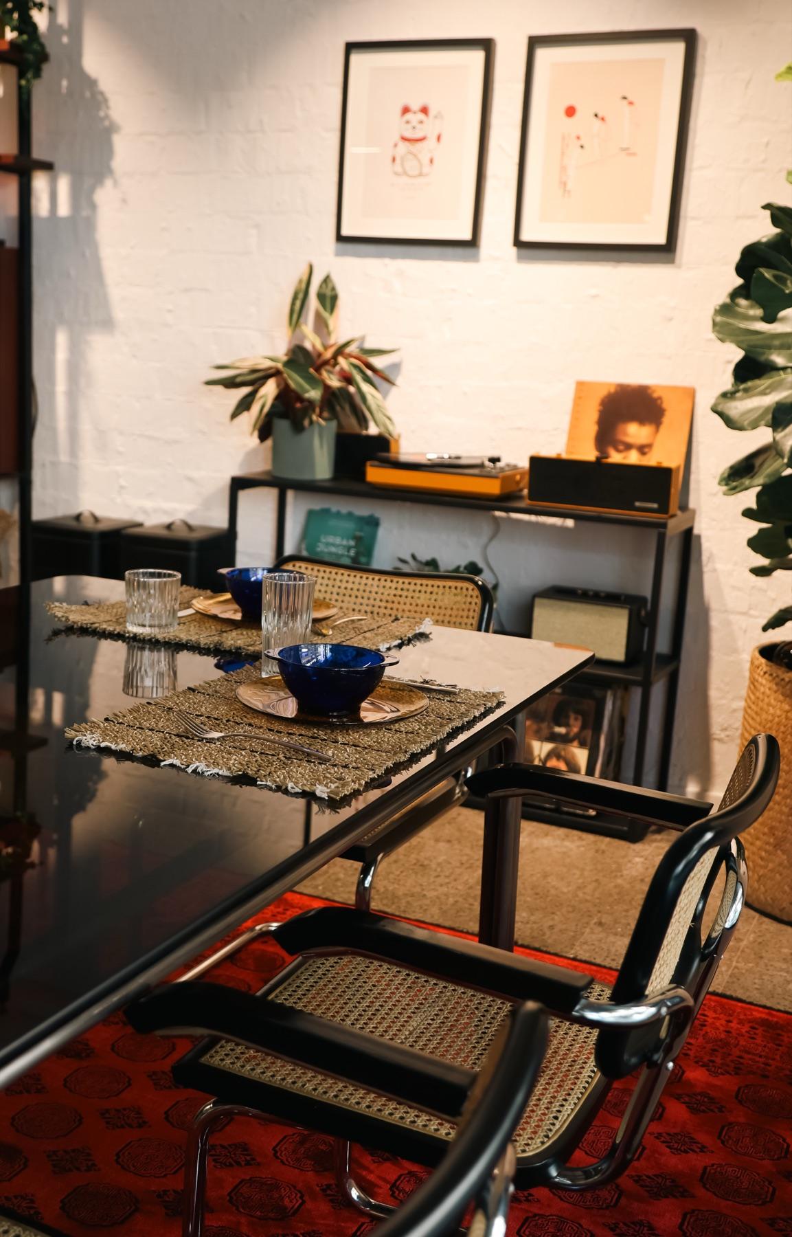 Communal table with tableware and artwork